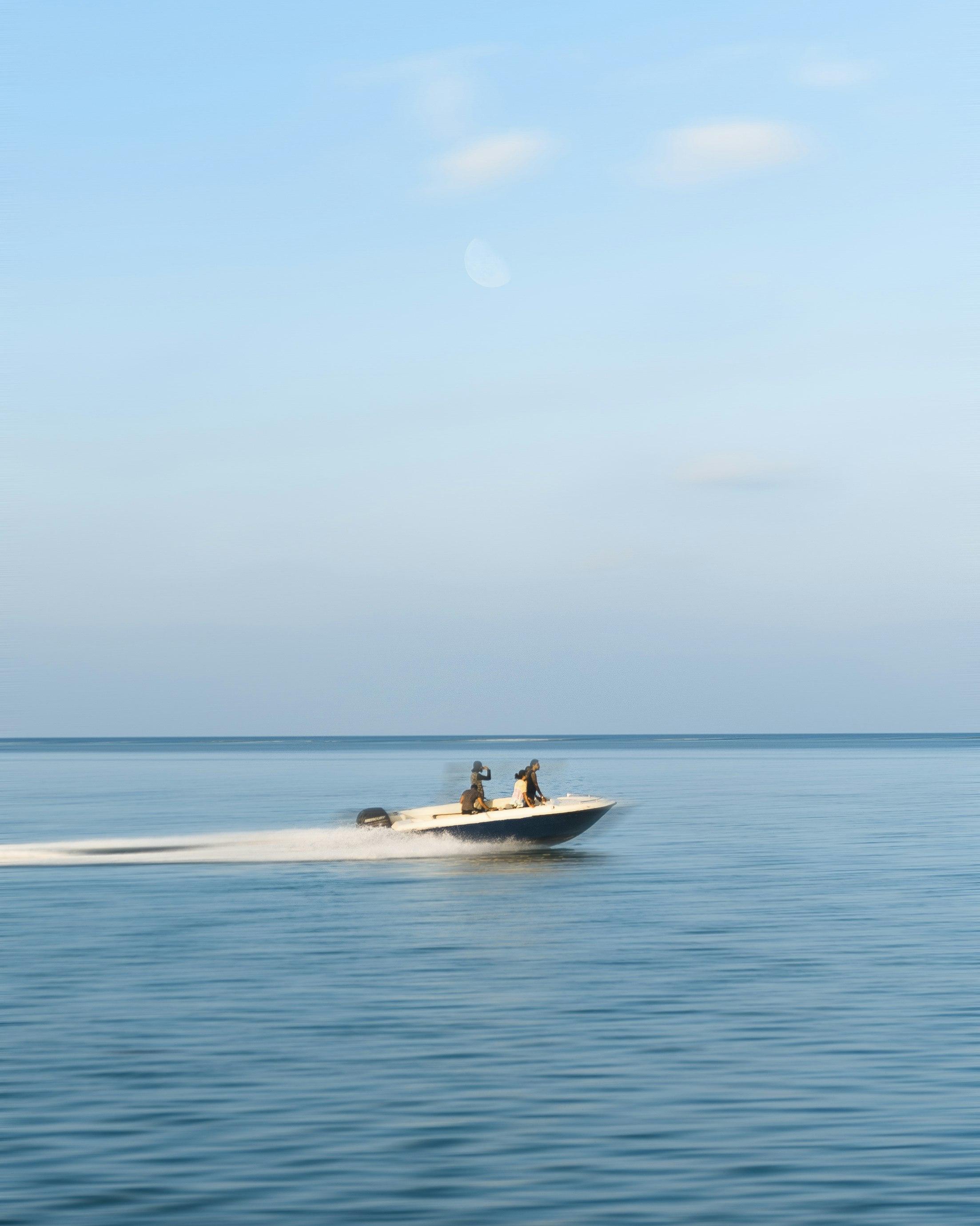 A center console boat gliding across calm open water off Palm Beach