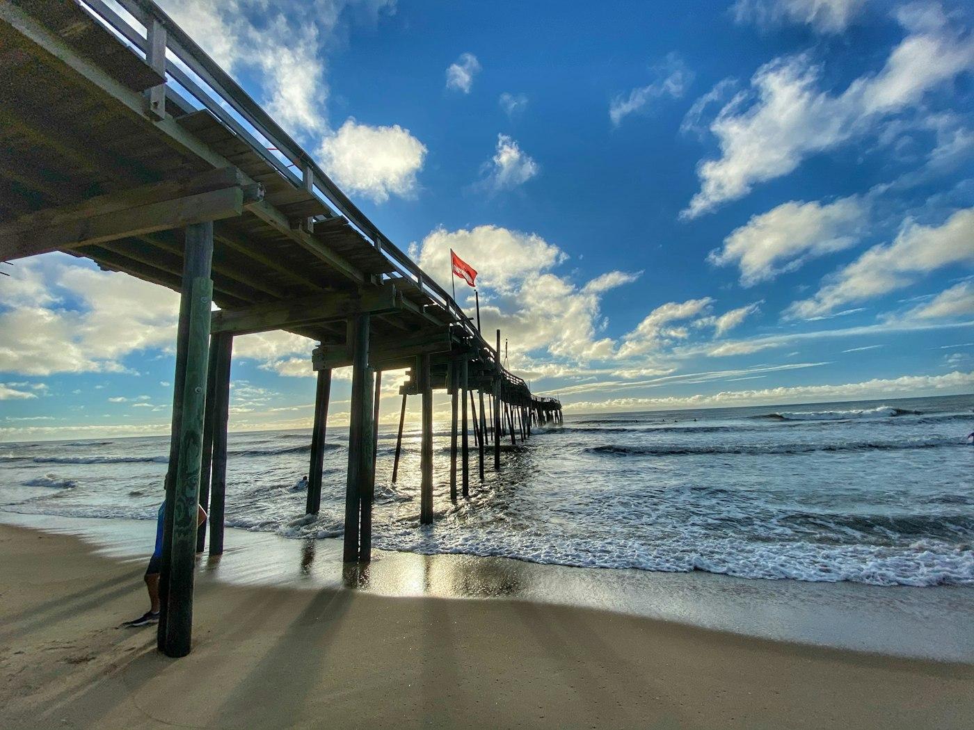 Juno Beach pier reaching over the water on a clear morning