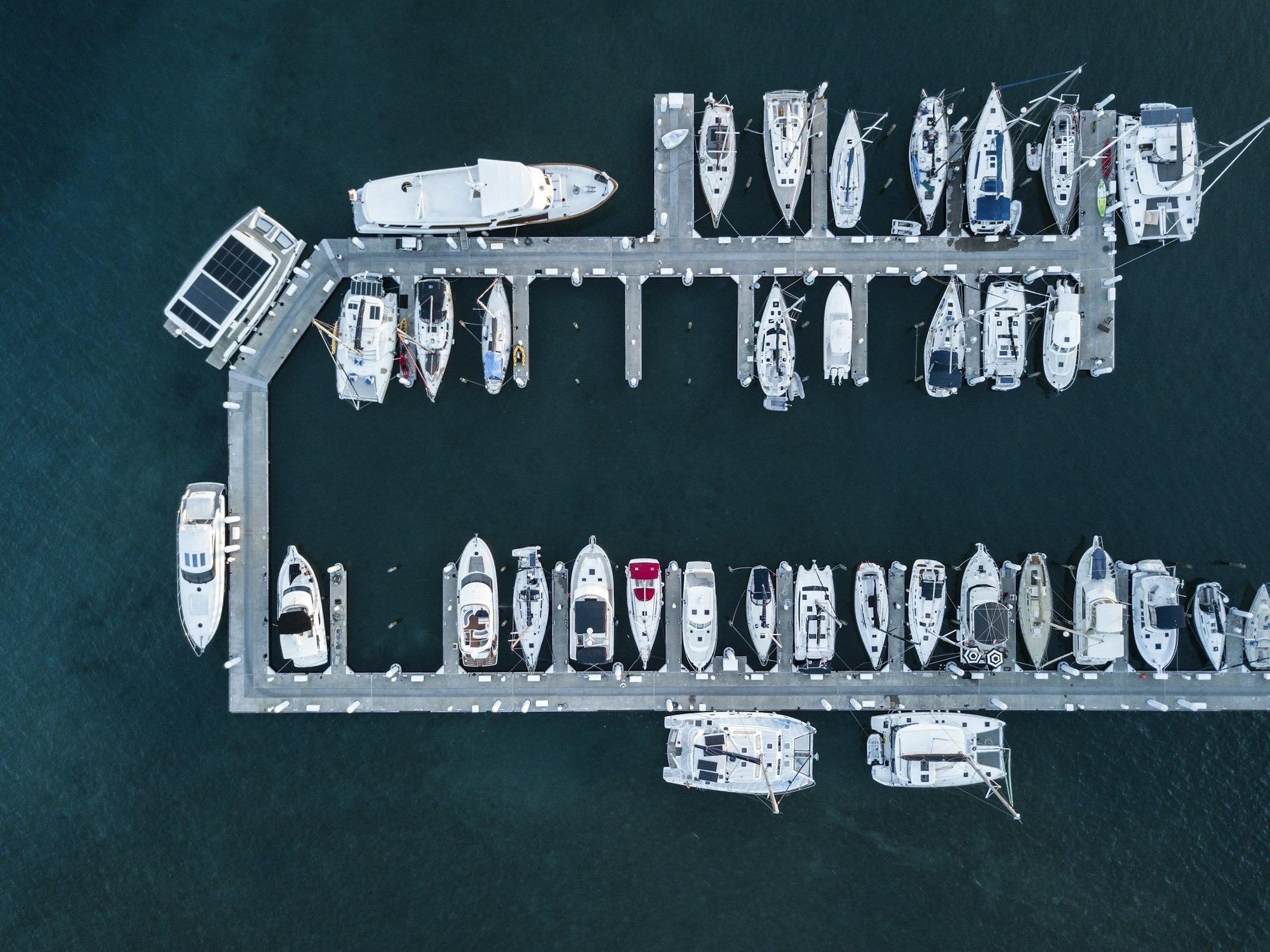 Aerial view of boats moored in a marina at first light